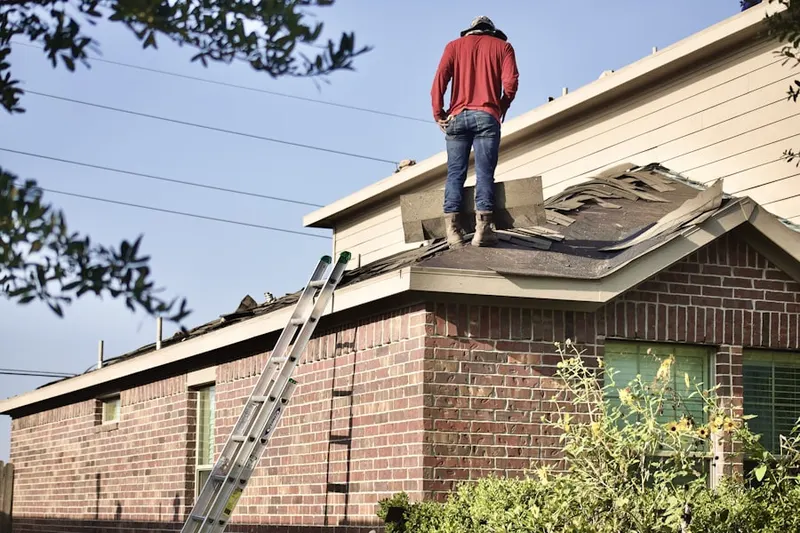 Professional roofer working on a residential roof in Pleasant Acres